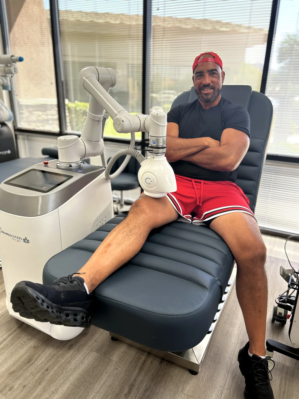 Devin Clark using the PainRecovery PEMF robotic arm applicator on his knee